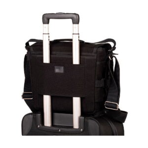 The Think Tank Retrospective 20 V2.0 - Black attaches securely to your roller bag, and its back sleeve slips over your suitcase handle for easy transport.
