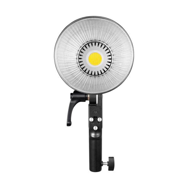 Godox ML60Bi Led videovalo -LED-valossa on suuri pyöreä heijastin, musta kahva, jossa on ohjauspainikkeet ja säätönuppi, sekä keskeinen keltainen LED-valonlähde studiovideovalaistukseen.
