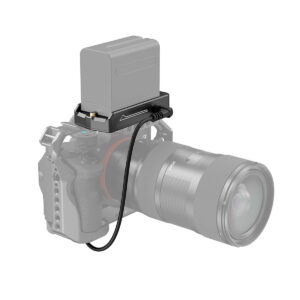 The camera with the large lens is connected by a short cable to the SmallRig 3095 NP-F Battery Adapter Plate Lite, which has the NP-FZ100 dummy battery mounted on top and is pictured against a white background.