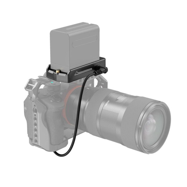 The camera with the large lens is connected by a short cable to the SmallRig 3095 NP-F Battery Adapter Plate Lite, which has the NP-FZ100 dummy battery mounted on top and is pictured against a white background.