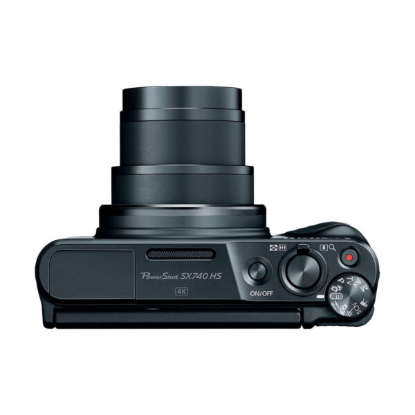 Top view of the black Canon PowerShot SX740 HS compact camera with extended zoom lens, control dial and On/Off button visible; model name and 4K logo appear on the body.