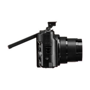 The Canon PowerShot SX740 HS compact camera is shown from the side, with its LCD screen turned out and at an angle, pop-up flash raised and lens fully extended.