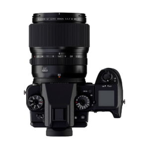 Top view of a Fujifilm camera with the Fujifilm Fujinon GF 80mm f/1.7 R WR lens mounted, with the control dials, buttons and digital display highlighted on the right.