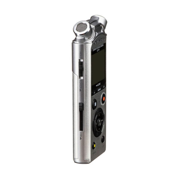 Olympus_LS-P1_0004 The Olympus LS-P1 audio recorder, a compact silver device with a display, several buttons, a built-in microphone at the top and memory card slots at the side, is pictured vertically on a white background.