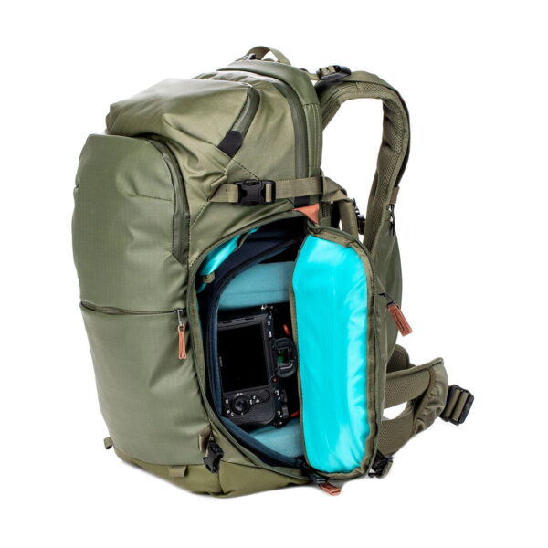 Shimoda Designs Explore v2 25 Starter Kit Camera Backpack, Green When opened, the side compartment reveals a padded bright blue interior that securely holds the camera with the lens facing out.