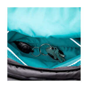 Close-up of the keys attached to the black plastic clip on the keyring, Shimoda Designs Explore v2 25 Starter Kit camera backpack, green.