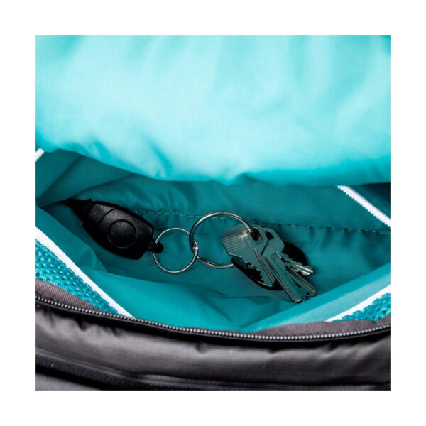 Close-up of the keys attached to the black plastic clip on the keyring, Shimoda Designs Explore v2 25 Starter Kit camera backpack, green.