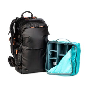 The Shimoda Designs Explore v2 30 camera backpack, black, is shown with brown zipper pulls next to a removable turquoise interior with customizable padded dividers for organizing camera gear.