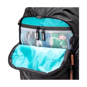 The close-up of the Shimoda Designs Explore v2 30 Camera Backpack, Black shows its turquoise interior with a mesh zip pocket for travel essentials such as a passport and luggage tag.