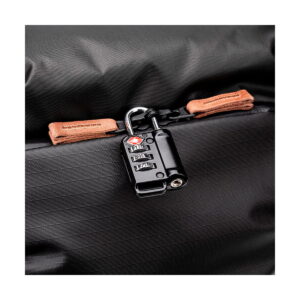 Close-up Shimoda Designs Explore v2 30 camera backpack in black with a secure black TSA-approved combination lock and tan leather drawstring pulls.