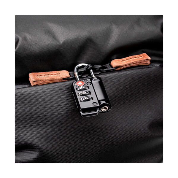 Close-up Shimoda Designs Explore v2 30 camera backpack in black with a secure black TSA-approved combination lock and tan leather drawstring pulls.