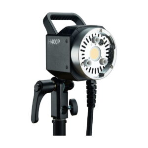 The Godox AD-H400P Flashhead Jatke studio video light, featuring a circular design with vents and adjustment knob, is mounted on a black stand with adjustable arm and attached power cord.