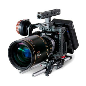 A professional Panasonic Lumix camera with a large Orion 40mm T2 lens, mounted on metal rods and equipped with the Tilta Nucleus-Nano wireless focus control system, grip and monitor, all against a white background.