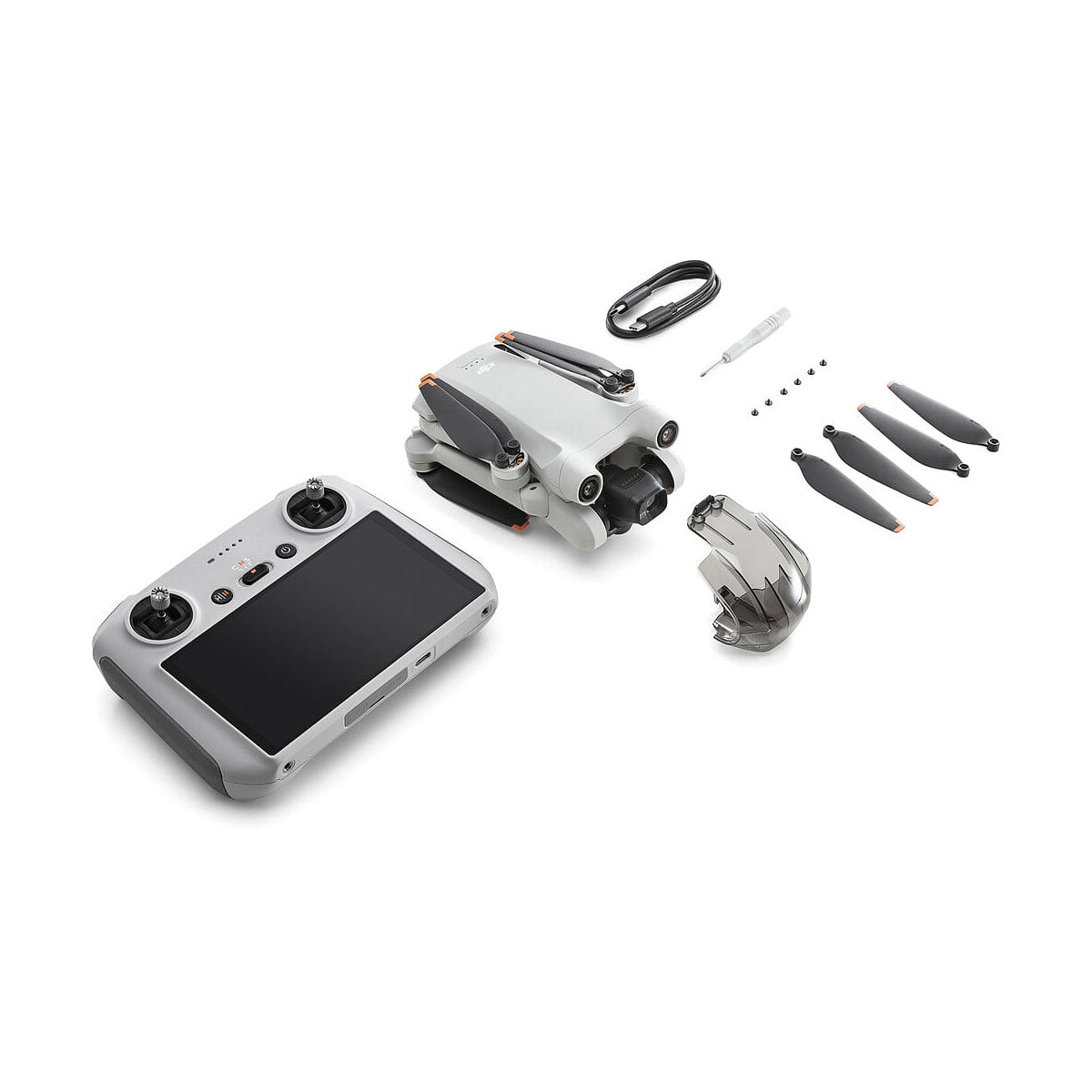 DJI Mini 3 Pro + Smart Controller -pakkaus sisältää kokoontaitetun lennokin, älykkään ohjaimen, akun, latauskaapelin, ruuvimeisselin, neljä potkuria ja neljä pientä ruuvia, jotka on järjestetty siististi valkoiselle taustalle.