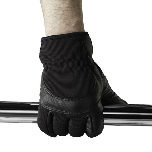 The person wearing the Kupo KH-55MB Ku-Hand Grip Gloves Goatskin - Medium grips the shiny metal bar against a white background, with only the glove hand and part of the forearm visible.