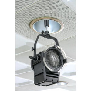 The Kupo KS-127 Recessed Light Socket 5/8" Baby Pin Adapter attaches a black stage spotlight to the ceiling and places it under a circular vent in the white perforated ceiling tile.