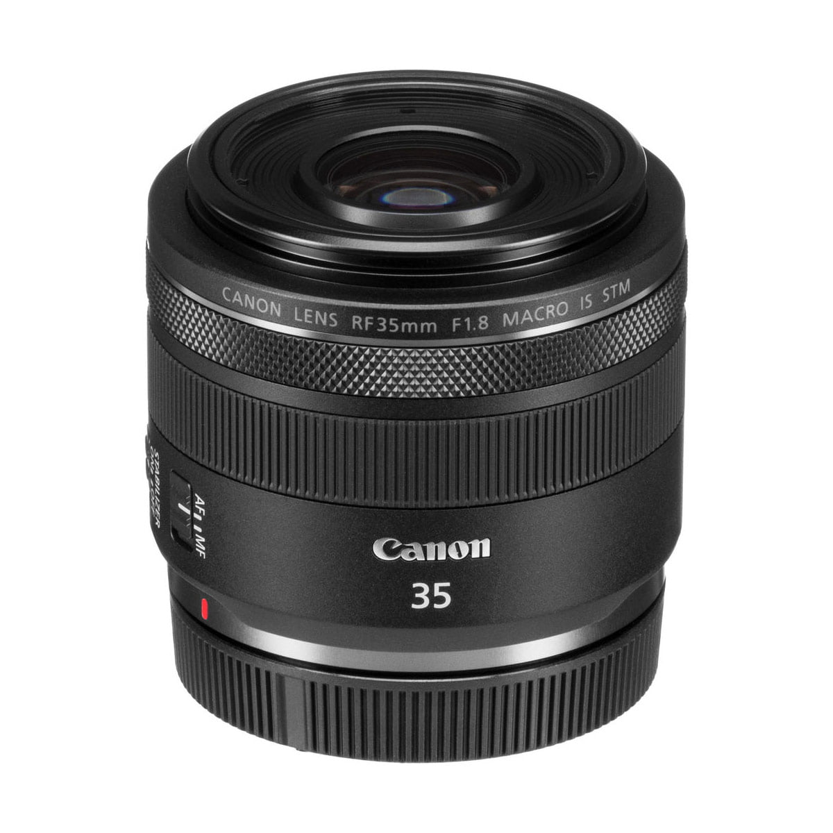 Canon RF 35mm f/1.8 Macro IS STM -objektiivi on pystyssä valkoisella pohjalla, ja sen tuotemerkki ja yksityiskohtaiset merkinnät ovat näkyvissä objektiivin rungossa.