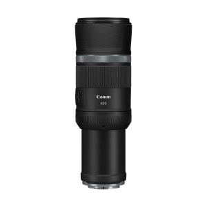 The Canon RF 600mm f/11 IS STM lens is upright on a white background, with a black body, textured grip and visible control dials.