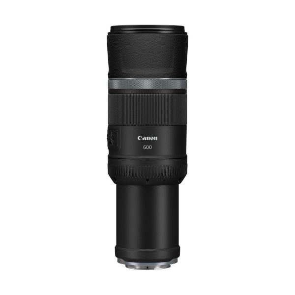The Canon RF 600mm f/11 IS STM lens is upright on a white background, with a black body, textured grip and visible control dials.