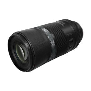A Canon RF 600mm f/11 IS STM lens, black construction, against a white background. The lens has a milled grip, focus adjustment ring, detailed markings and a switch on the side.
