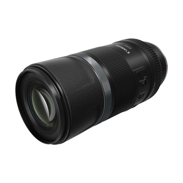A Canon RF 600mm f/11 IS STM lens, black construction, against a white background. The lens has a milled grip, focus adjustment ring, detailed markings and a switch on the side.