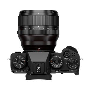Fujifilm X-T5 system camera top viewfinder, black, with large lens mount. The camera has dials and buttons for shutter speed, ISO, exposure and power on/off.