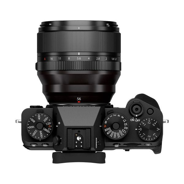 Fujifilm X-T5 system camera top viewfinder, black, with large lens mount. The camera has dials and buttons for shutter speed, ISO, exposure and power on/off.