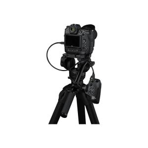 The digital camera on the tripod is connected by cables to the Nikon MC-N10 remote control handle, which is attached to one of the tripod legs. The camera's rear display and control buttons are visible.