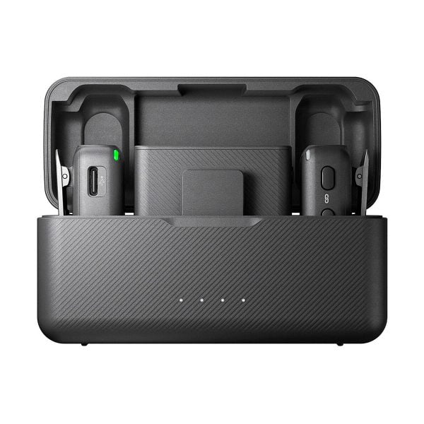 The DJI Mic Dual Kit wireless microphone system is a black charging case with an open lid that houses two wireless microphone transmitters and a receiver. Four indicator lights appear on the front of the case.