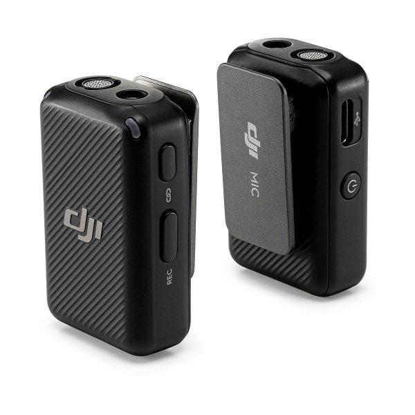 The two black DJI Mic Dual Kit Wireless Microphone System transmitters feature textured surfaces, side buttons and visible DJI logos. One shows a power button and USB port; the other has a holder with DJI MIC labeling.