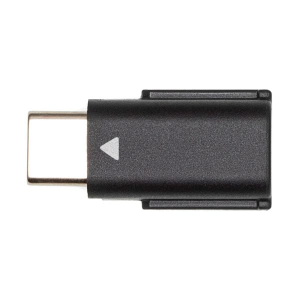 A DJI Mic Dual Kit wireless microphone system USB-C adapter, black, with a small white arrow on the body, featured on a white background.