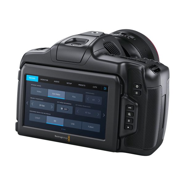 The BLACKMAGIC Pocket Cinema Camera 6K G2 is visible from the back and features a touchscreen interface with a variety of settings. The black camera body has several control buttons next to the screen.
