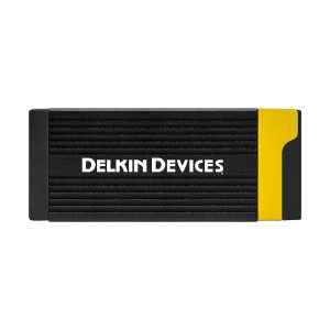 Black Delkin CFexpress Type A & SD memory card reader with horizontal grooves and yellow accent on the right side, front view.