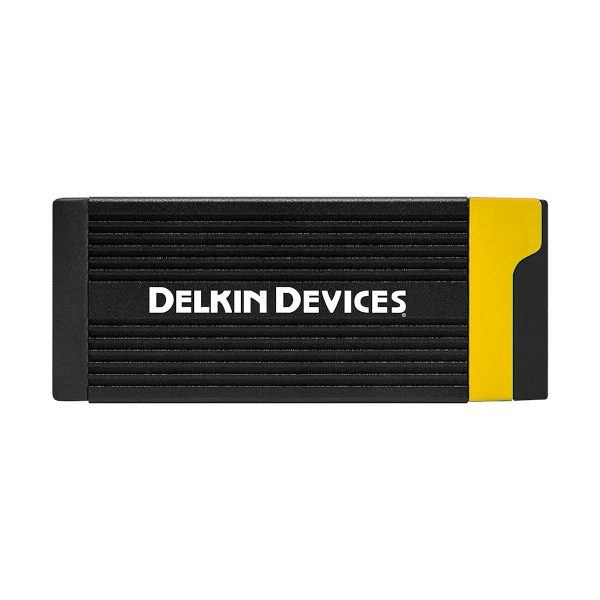 Black Delkin CFexpress Type A & SD memory card reader with horizontal grooves and yellow accent on the right side, front view.