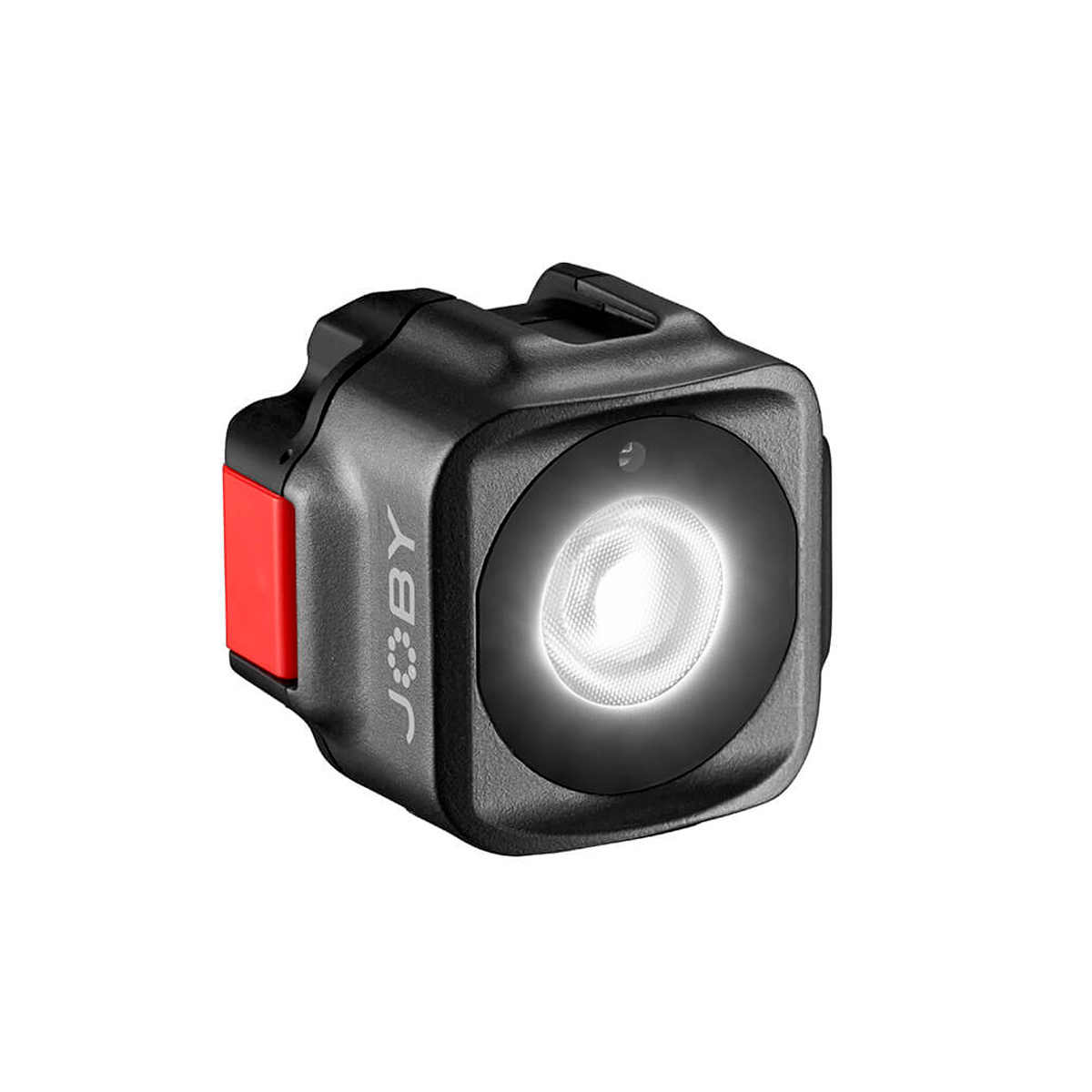 Pienikokoinen, musta, kuution muotoinen Joby Beamo Mini - LED-valo, jossa on punainen sivupainike ja pyöreä valaistu etuosa, kuvassa valkoisella pohjalla.