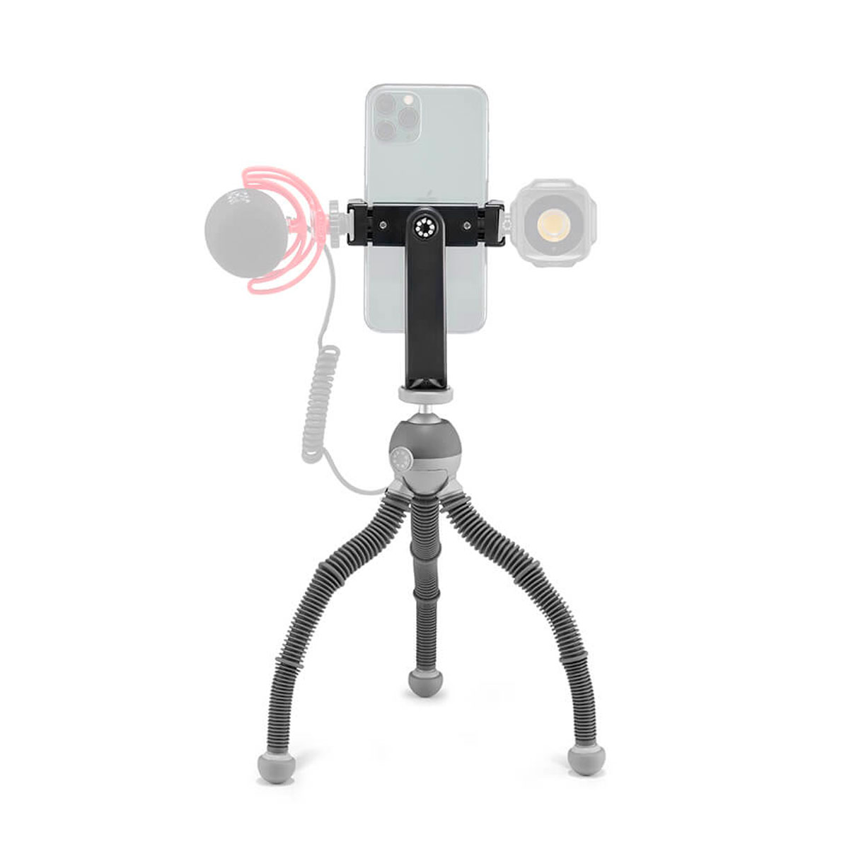 Joby PodZilla Flexible Tripod Kit M Harmaa pitää sisällään älypuhelimen, ja siinä on kiinnikkeet valinnaiselle mikrofonille ja pienelle LED-valolle, jotka on esitetty harmaalla merkiksi siitä, että ne eivät sisälly toimitukseen.