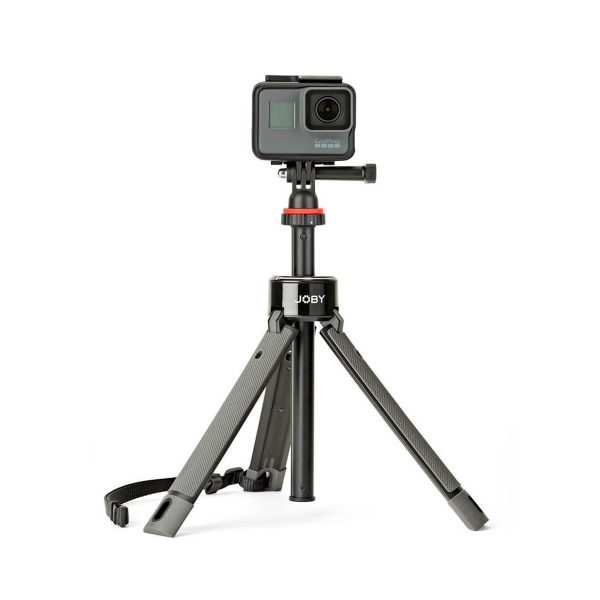 A small black action camera is mounted on the Joby TelePod Pro Kit, a compact tripod with extendable legs and carrying strap, against a white background.