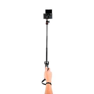 A hand holding the Joby TelePod Pro Kit and its mounted digital camera against a white background.