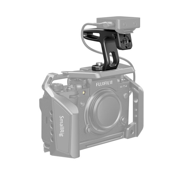 SmallRig camera cage with Fujifilm X-T4 and SmallRig 2756 Mini Top Handle for Lightweight Cameras and an external device connected to the handle with a cable.