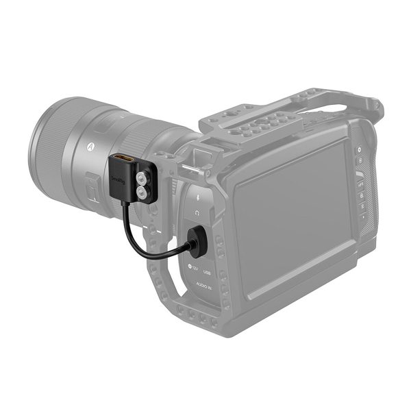 The SmallRig 3019 HDMI Ultra Slim Adapter Cable 4K (A-A) is connected by a short cable to the side of a digital camera with a protective housing and a large lens, showing how to attach the adapter.