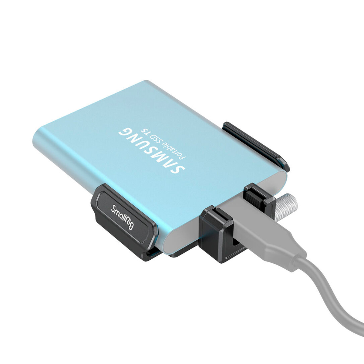 The light blue Samsung Portable SSD T5 is connected with a cable and secured with the black SmallRig 3272 T5/T7 SSD Mount for BMPCC 6K Pro.