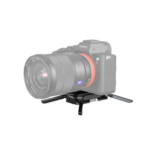 SmallRig-3913-2 A Sony Alpha camera with a large lens is attached to the compact black SmallRig 3913 Arca Type Multifunctional Quick Release Plate with two folding feet facing outwards. The semi-transparent camera highlights the mounting plate.