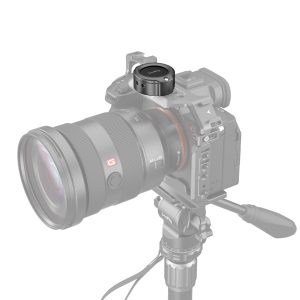 The grey-toned digital camera with a large lens is on a stand with a SmallRig 4149 Cage for Apple AirTag, which securely mounts the device above the camera.