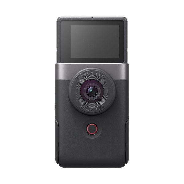 The Canon PowerShot V10 silver compact camera is a black digital camera with a large circular lens, a red button below the lens and a forward-facing LCD screen at the top.