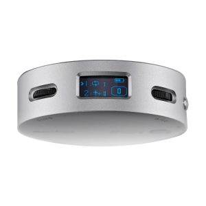 The Godox R1 is a round, silver-coloured electronic device with a small rectangular digital display with blue icons and numbers and two black control dials next to it.
