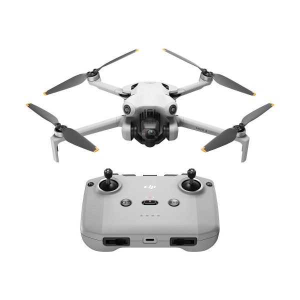 The grey DJI Mini 4 Pro drone with four propellers and a camera is pictured above a matching grey remote control with two joysticks and several buttons on a white background.