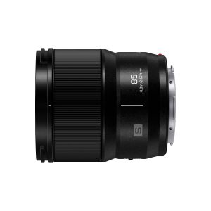 The Panasonic Lumix S 85mm f/1.8 lens appears in side profile against a white background, with black textured and smooth parts, 85 and 0.80m/2.62ft markings and a metal mounting ring.