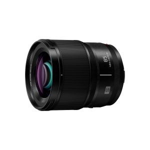 The Panasonic Lumix S 85mm f/1.8 lens is a black lens with "85" and "S" markings, a textured focusing ring and purple and blue reflective glass elements isolated on a white background.