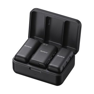 The black charging case is opened and inside are three compact Sony ECM-W3 wireless microphone units.