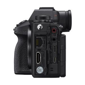 Side view of the Sony A9 III system camera from close-up, with its ports visible above the textured grip, showing HDMI, USB, audio, LAN and other connection ports.